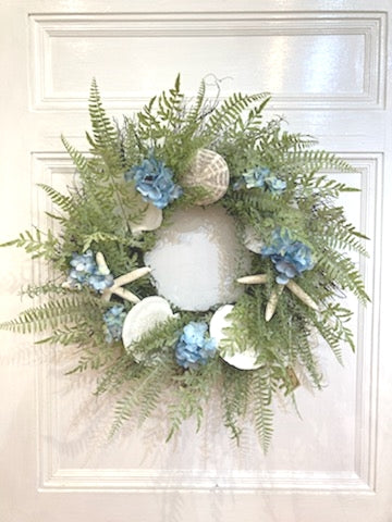 26"D Shell Wreath with UV Fern, Blue Hydrangea, white Finger Starfish and a Sea Urchin
